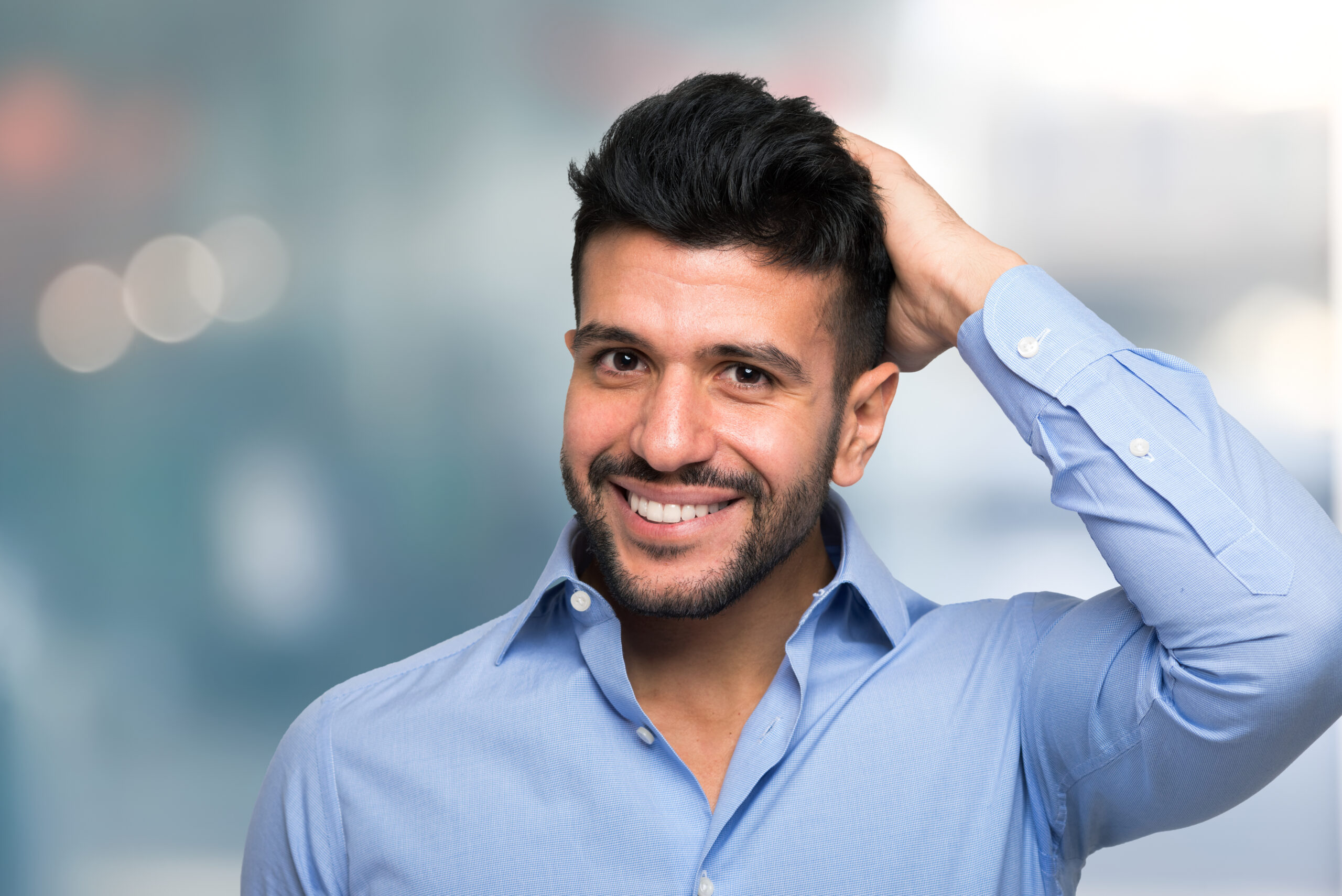 Portrait of a man touching his hair